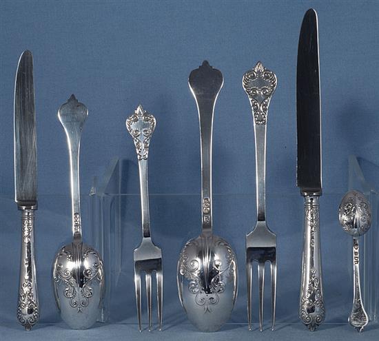 A George V silver canteen of 17th century style lace back trefid pattern cutlery, 110oz/ 3430 grams.